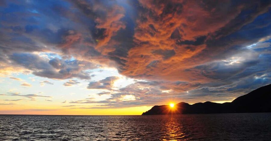 Cinque Terre: Sunset Cruise with Aperitif on Board - Monterosso: beaches, umbrellas, and the first coastal view