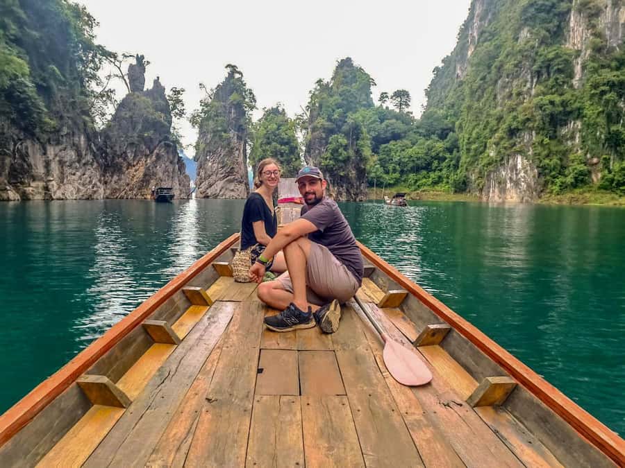 From Khao Lak: Khao Sok & Cheow Lan Lake Tour with Kayaking - Boarding the traditional long-tail boat at Rajjaprabha Dam