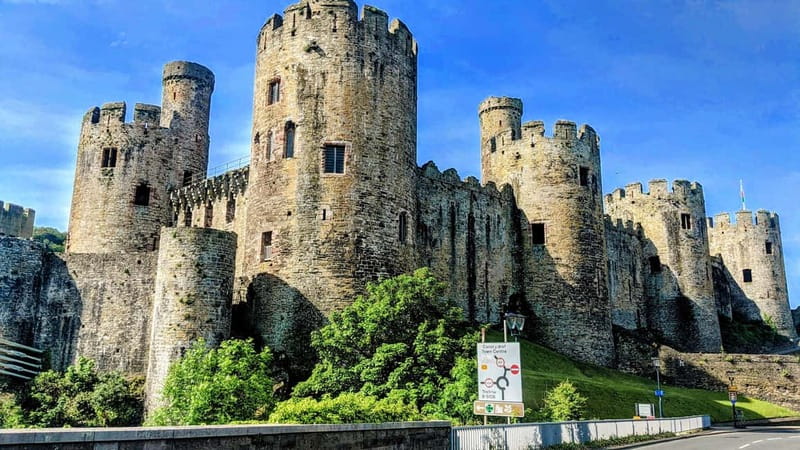 From Llandudno: Portmeirion, Snowdonia and Castles Tour - Caernarfon village and its immense castle walls