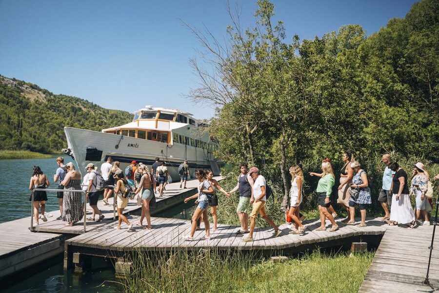 From Split: Krka Waterfalls Tour with Boat Cruise & Swimming - Cruising toward Skradin by panoramic boat